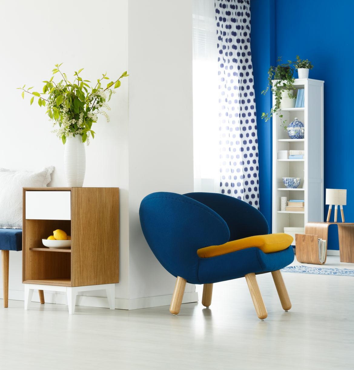 Blue chair in white room